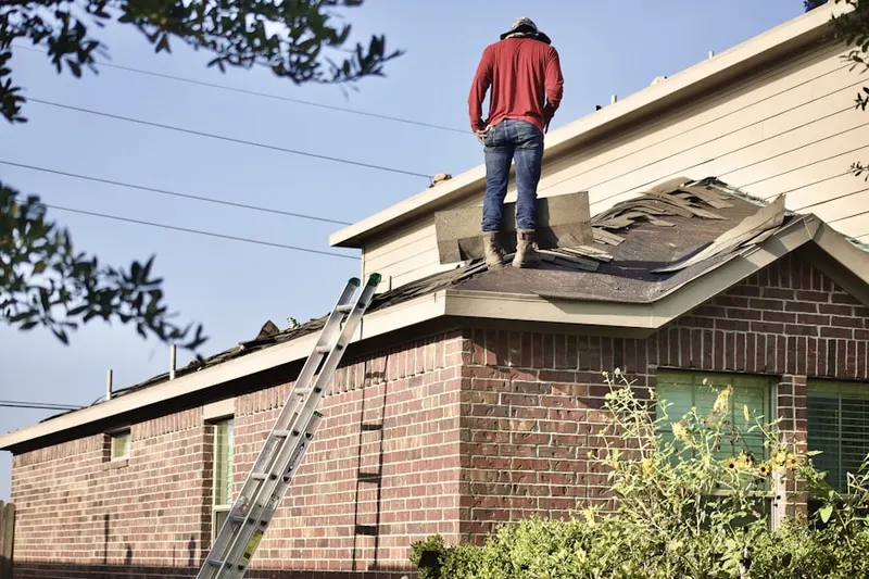 Professional roofer working on a residential roof in Glen Cove Estates